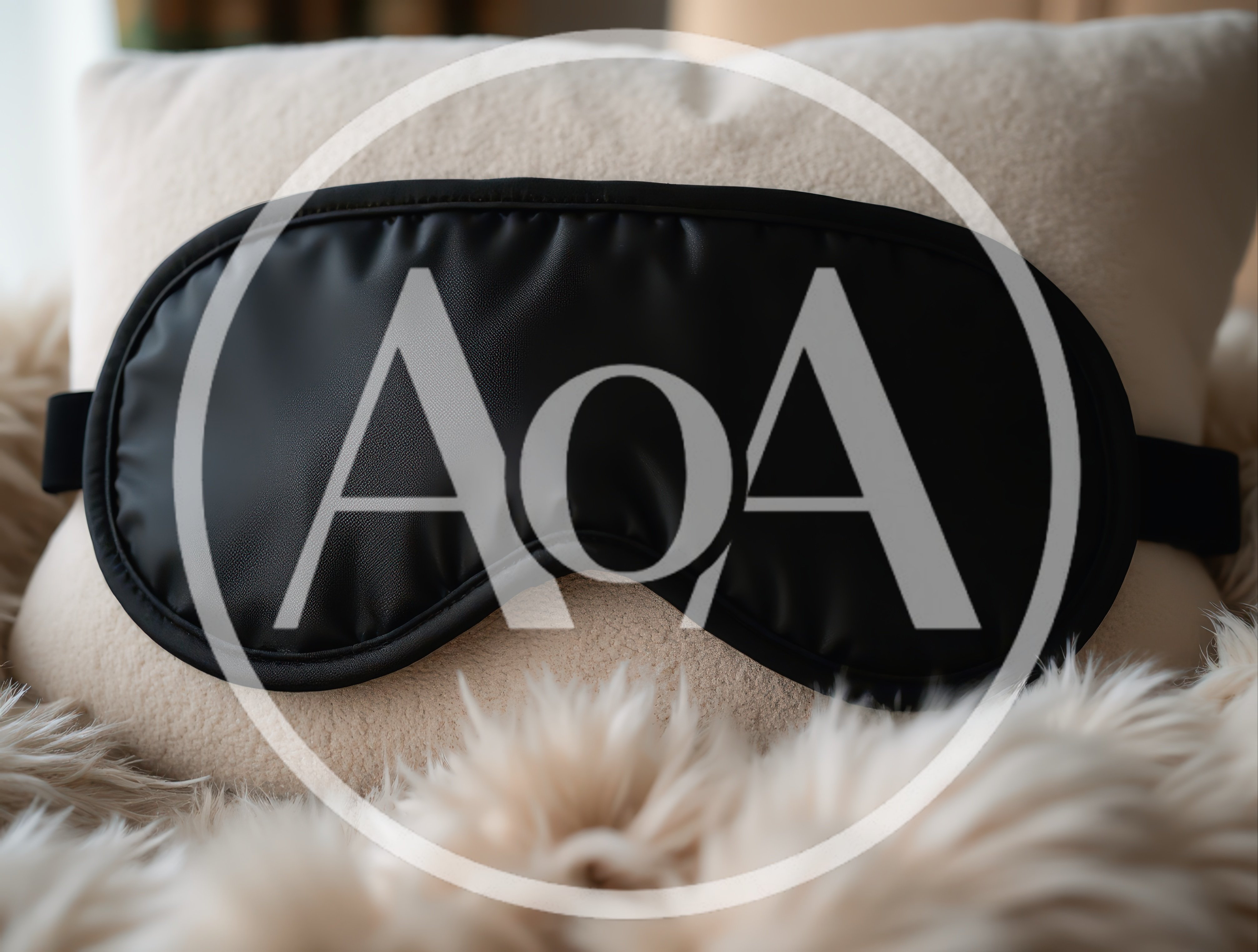Black Silk Sleep Mask Resting On A Fluffy Pillow