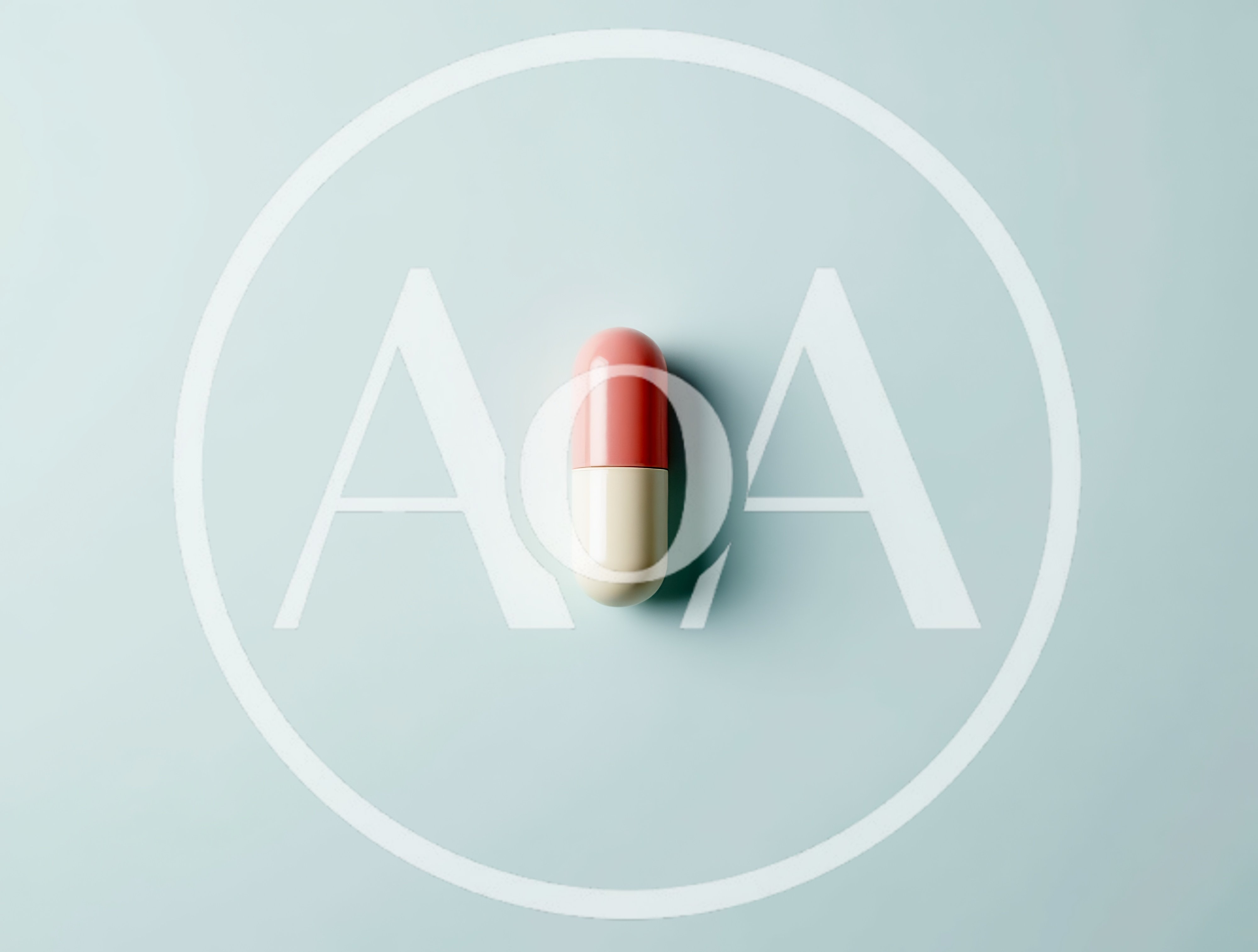 Single Pink and White Capsule Pill on Blue Background