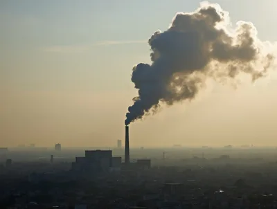 Industrial Smoke Stack Emitting Thick Pollution Over City