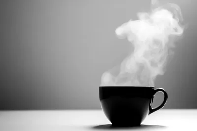 Steaming Black Coffee Cup On A Minimalist Surface