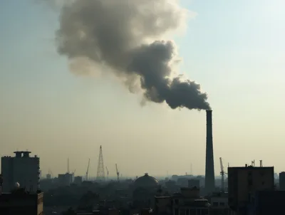 Industrial Smoke Rising From Factory Chimney Over City Skyline