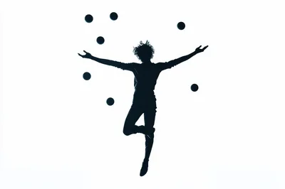 Silhouette of a Juggler Performing in Mid-Air