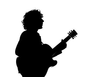 Silhouette Of A Musician Playing An Acoustic Guitar