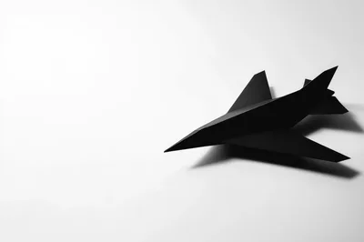 Black Paper Airplane On White Background