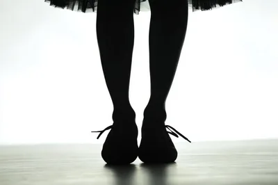 Silhouette Of A Dancer Standing In Ballet Shoes