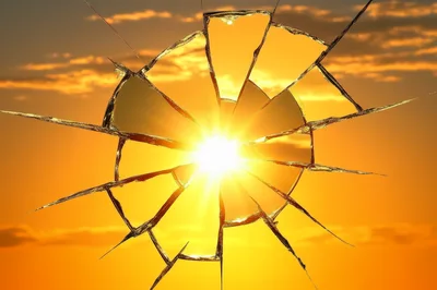 Sunlight Shining Through A Shattered Glass Window