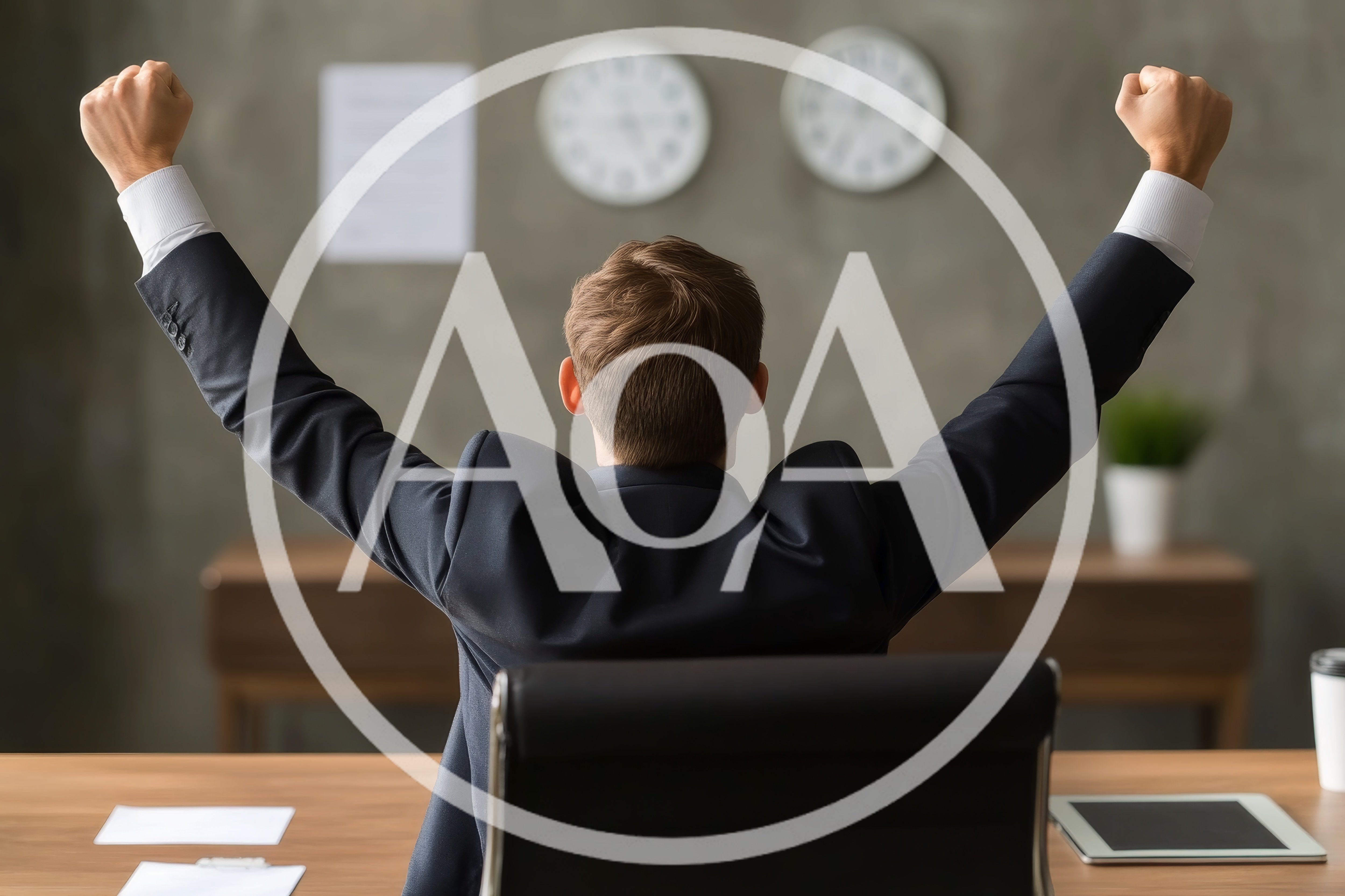 Businessman Celebrating Success With Arms Raised In Office