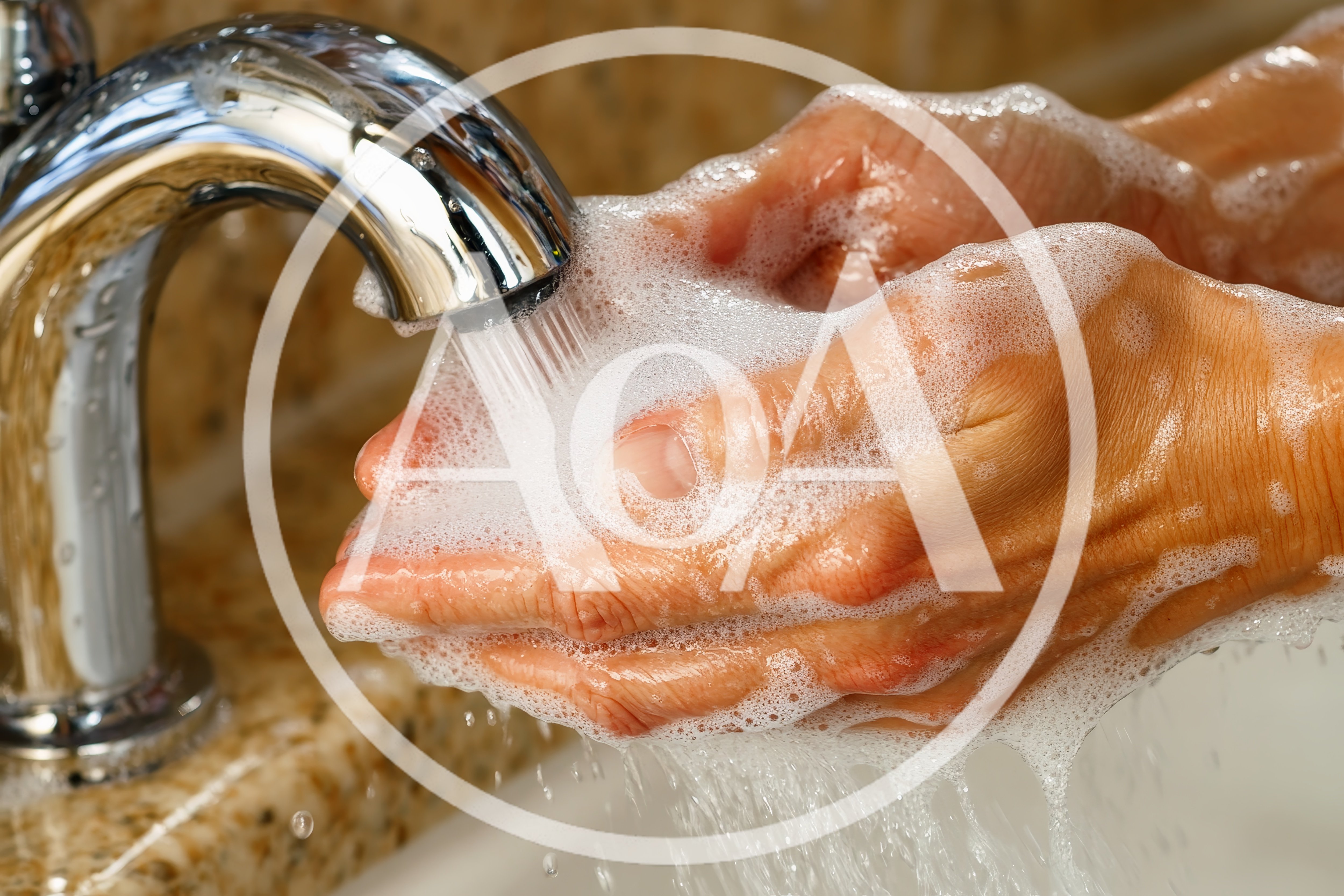 Person Washing Hands With Soap Under Running Water
