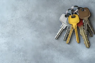 Bunch Of Metal Keys On A Concrete Surface