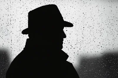 Silhouette Of A Man Wearing A Fedora Hat