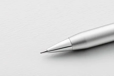 Close Up Of A Silver Ballpoint Pen On Paper