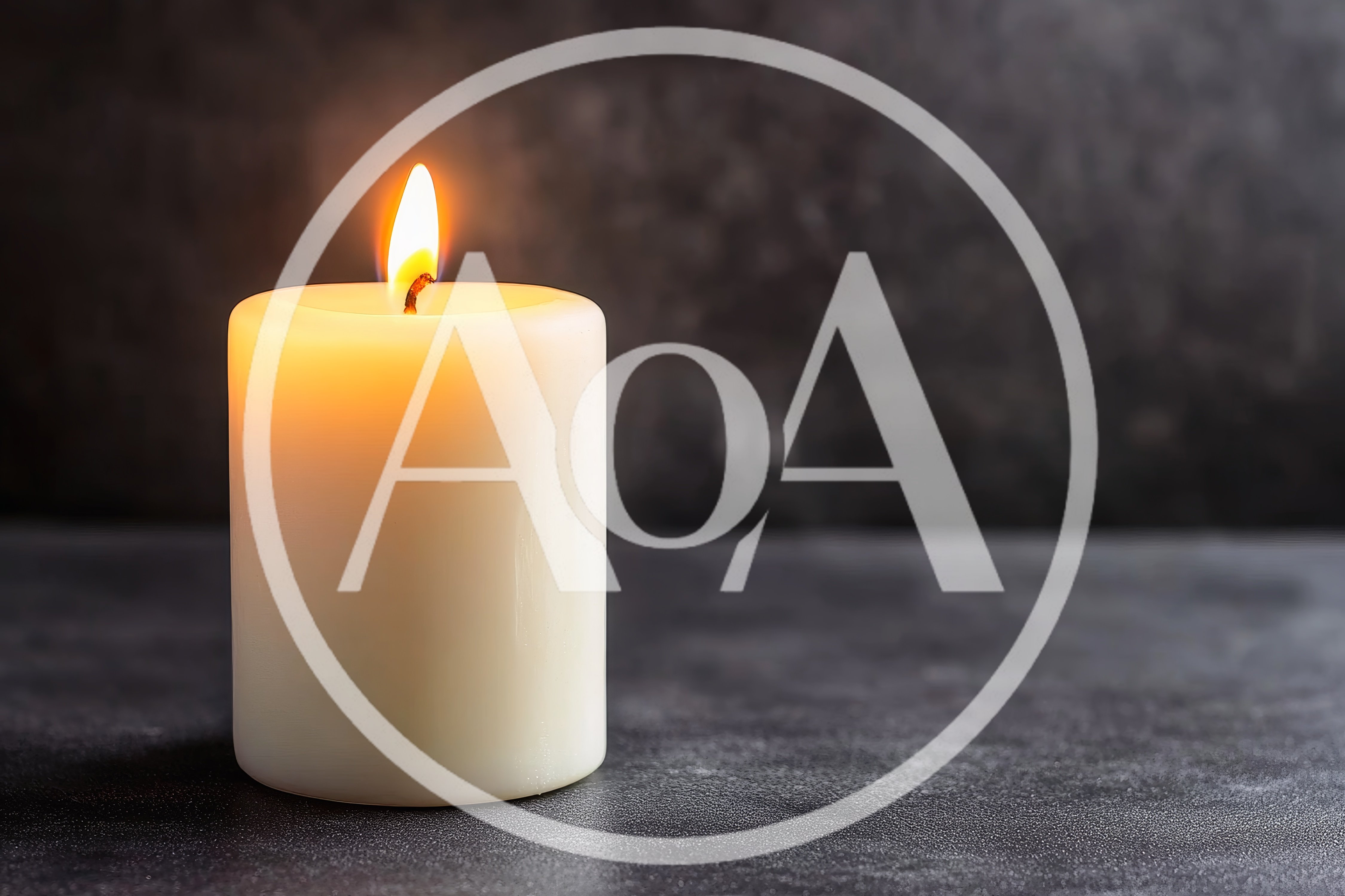 Lit White Pillar Candle on Dark Textured Surface