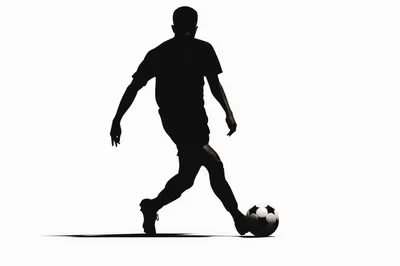 Silhouette Of A Soccer Player Dribbling A Ball