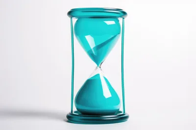 Teal Hourglass With Flowing Sand On White Background