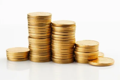 Stacks Of Shiny Gold Coins On White Background