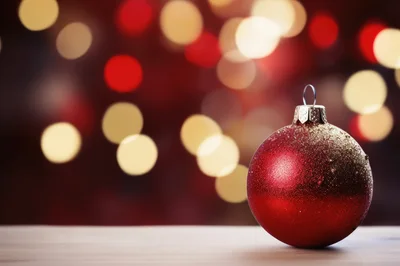 Red Christmas Ornament On Wooden Surface With Bokeh Background