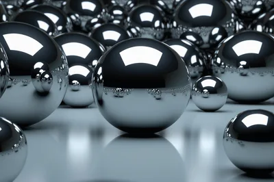 Polished Chrome Spheres Arranged On A Reflective Surface