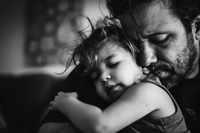 Father Embracing His Sleeping Young Daughter