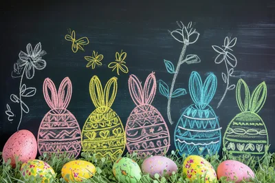 Easter Eggs And Chalk Bunny Drawings On Blackboard
