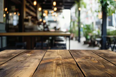 Empty Rustic Wooden Table In A Blurred Cafe Interior
