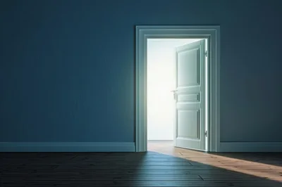 Open Doorway With Bright Light In Dark Room