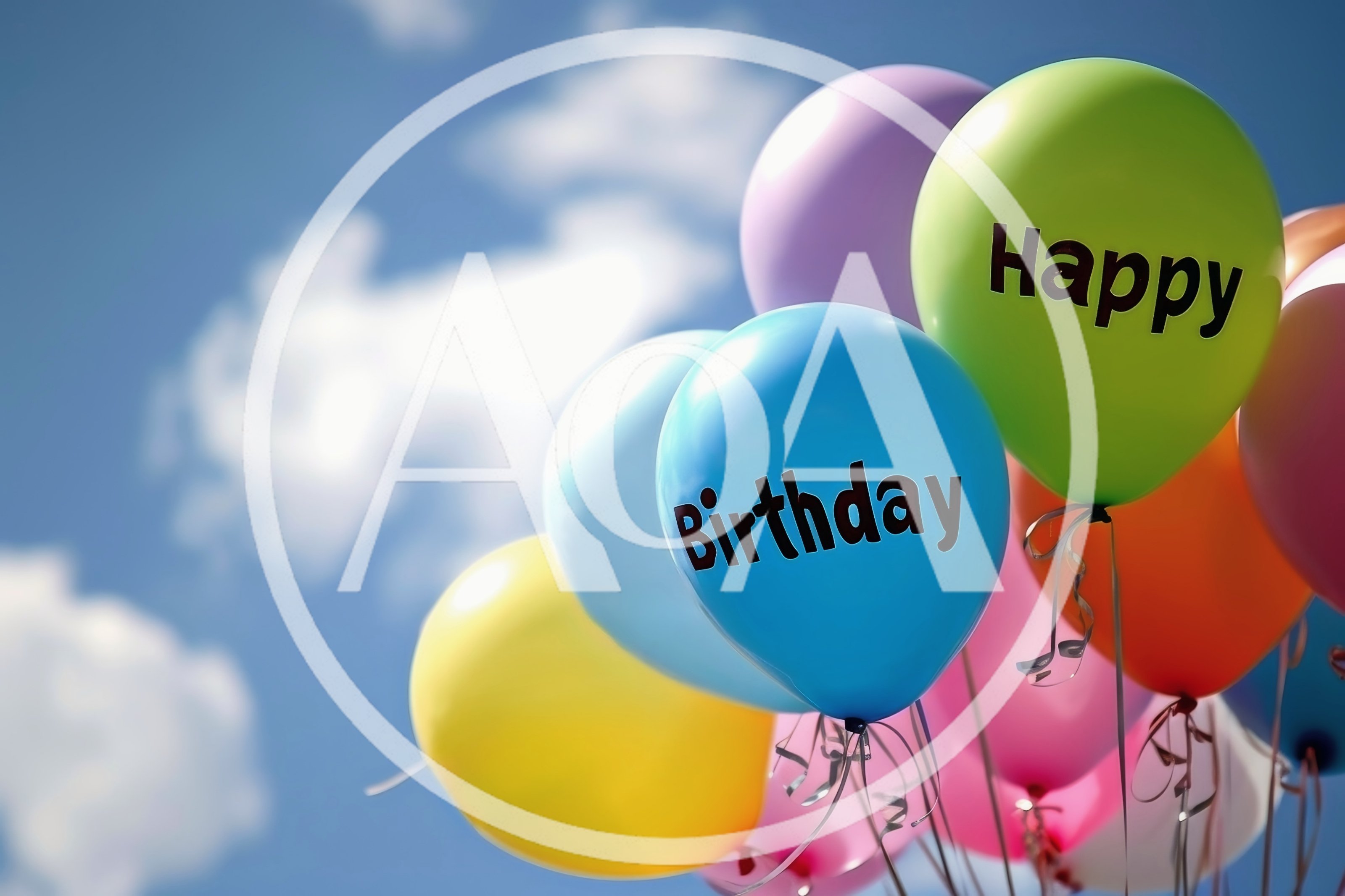 Colorful Happy Birthday Balloons Floating Against Blue Sky