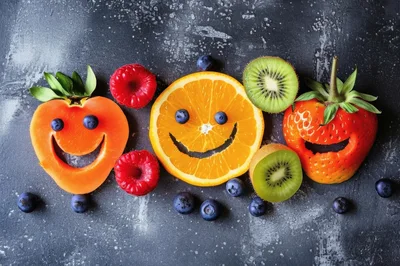 Creative Fruit Faces Arranged on Dark Textured Background
