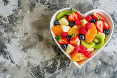 Heart Shaped Bowl Filled With Fresh Fruit Salad
