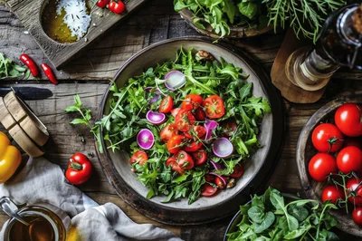 Fresh Salad Bowl With Tomatoes And Radishes On Wood