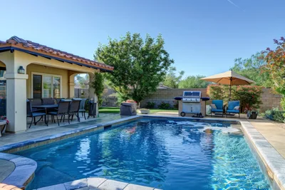 Backyard Patio With Swimming Pool And Outdoor Kitchen