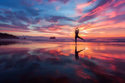 Woman Practicing Yoga Pose on Beach at Sunset