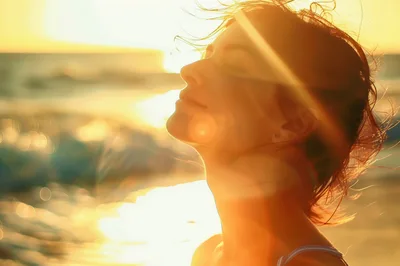 Woman Enjoying Warm Sunlight At The Beach