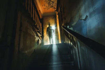 Silhouette Of A Man Standing In A Dark Hallway
