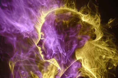 Abstract Profile Silhouette Surrounded By Swirling Purple And Gold Smoke