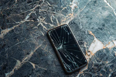 Broken Smartphone Screen On Dark Marble Surface