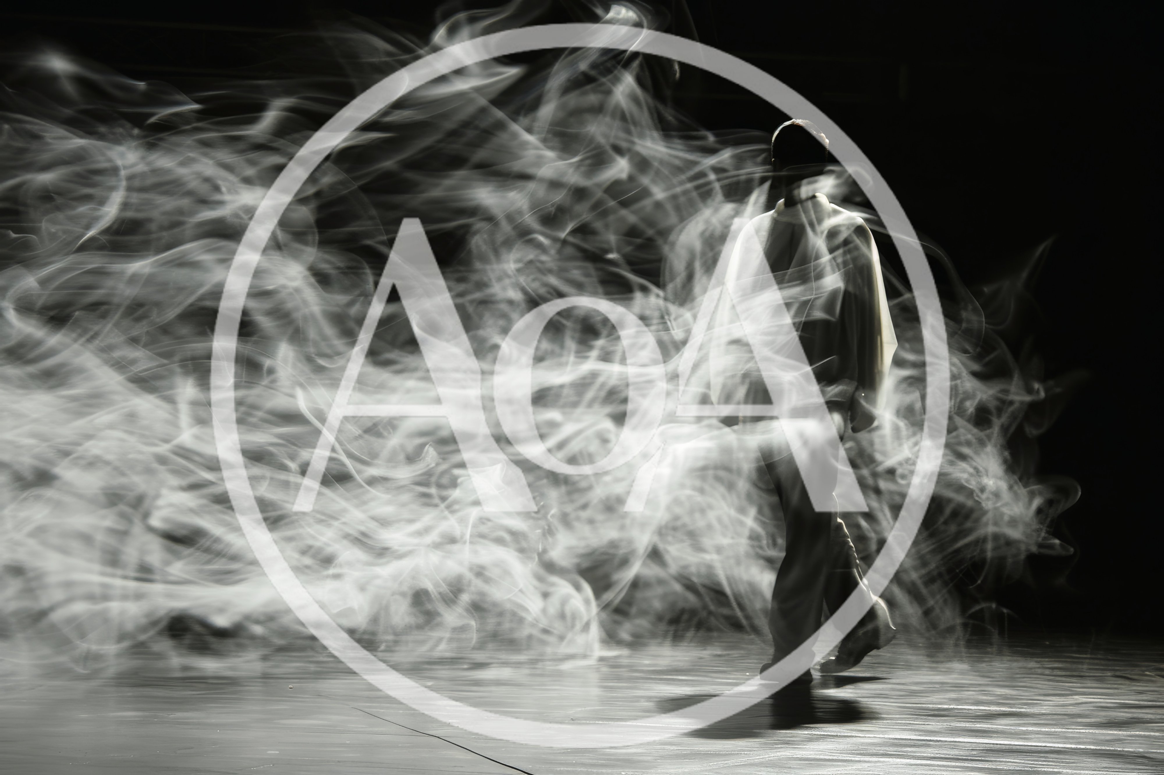 Dancer Moving Through Swirling Smoke On Stage