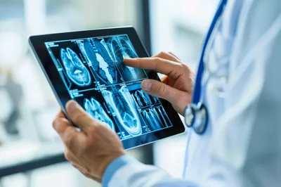 Doctor Examining Medical Imaging On A Digital Tablet