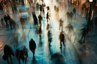 Blurred Pedestrians Walking Through A Busy City Square