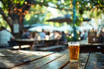 Glass Of Beer On A Wooden Table At An Outdoor Beer Garden
