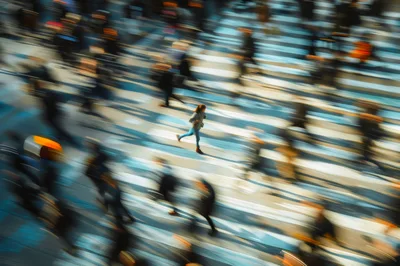 Woman Running Across A Busy City Crosswalk