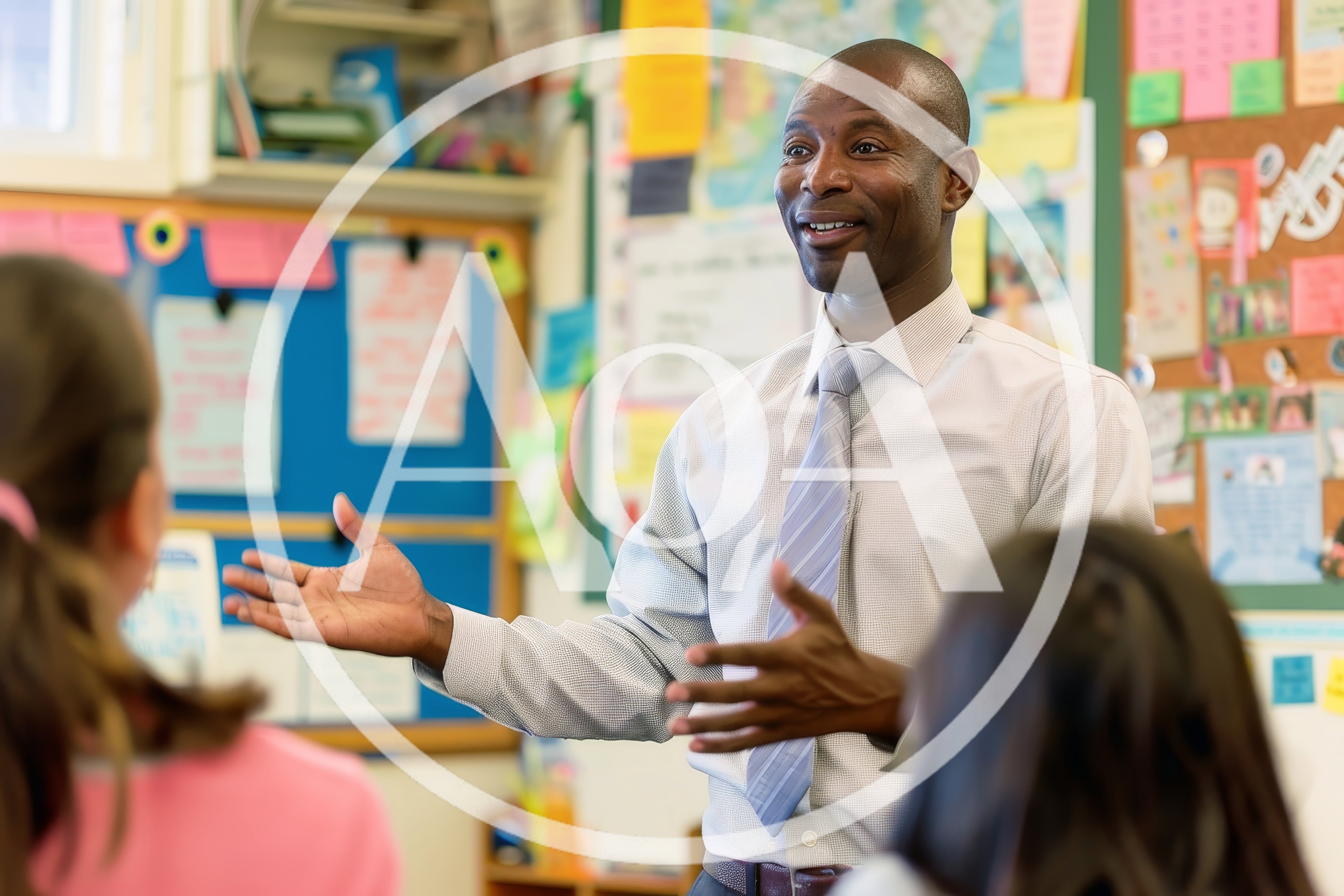 African American Male Teacher Instructing Students In Classroom