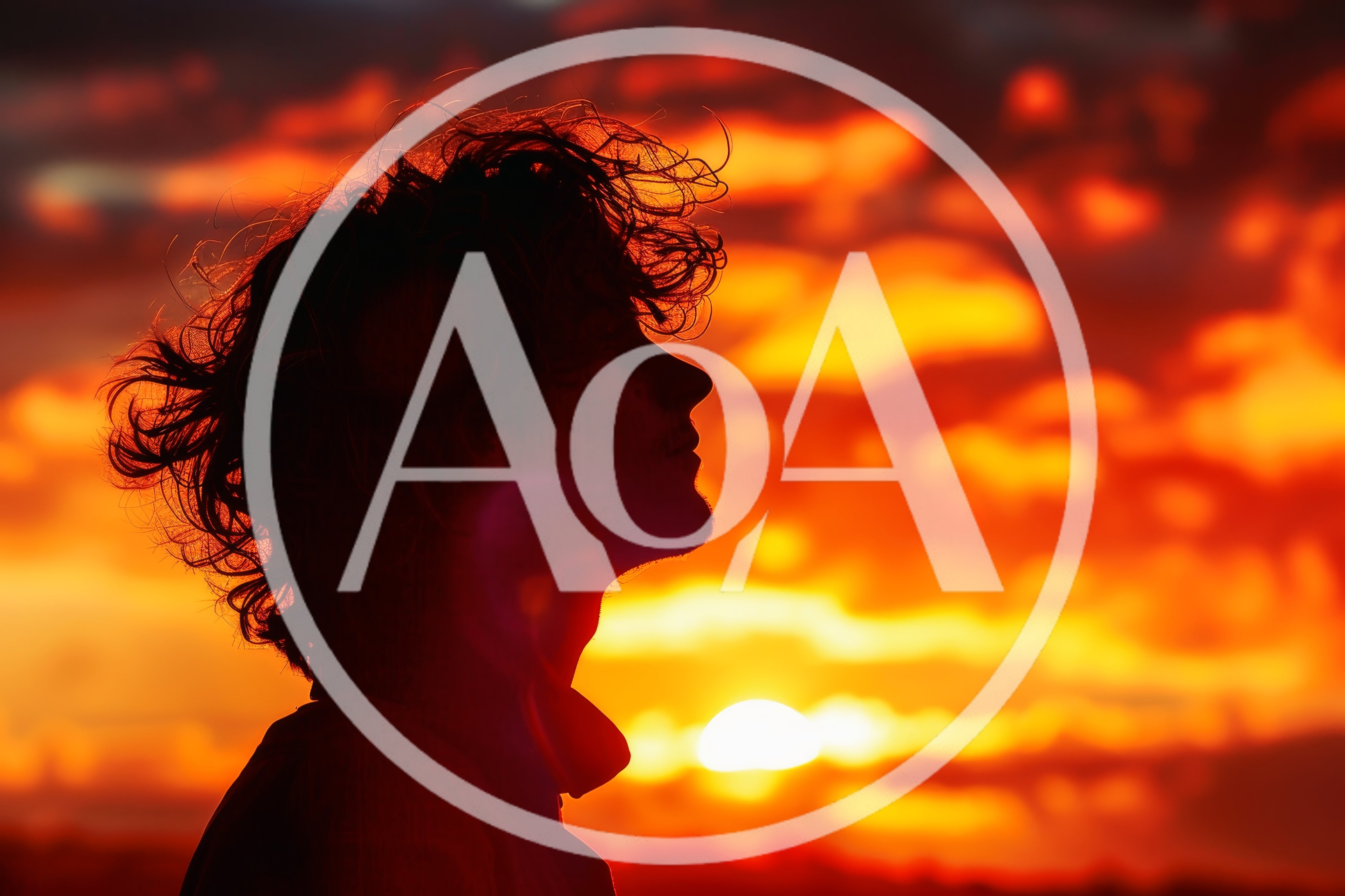 Silhouette Of A Young Man Against A Vibrant Sunset