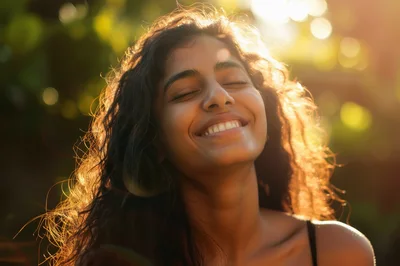 Young Woman Smiling With Eyes Closed In Sunlight