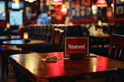 Reserved Sign On A Wooden Table In A Dimly Lit Pub