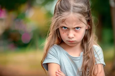 Angry Young Girl With Freckles Looking At Camera