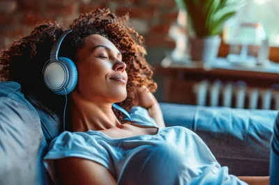 Relaxed Woman Listening To Music With Headphones At Home