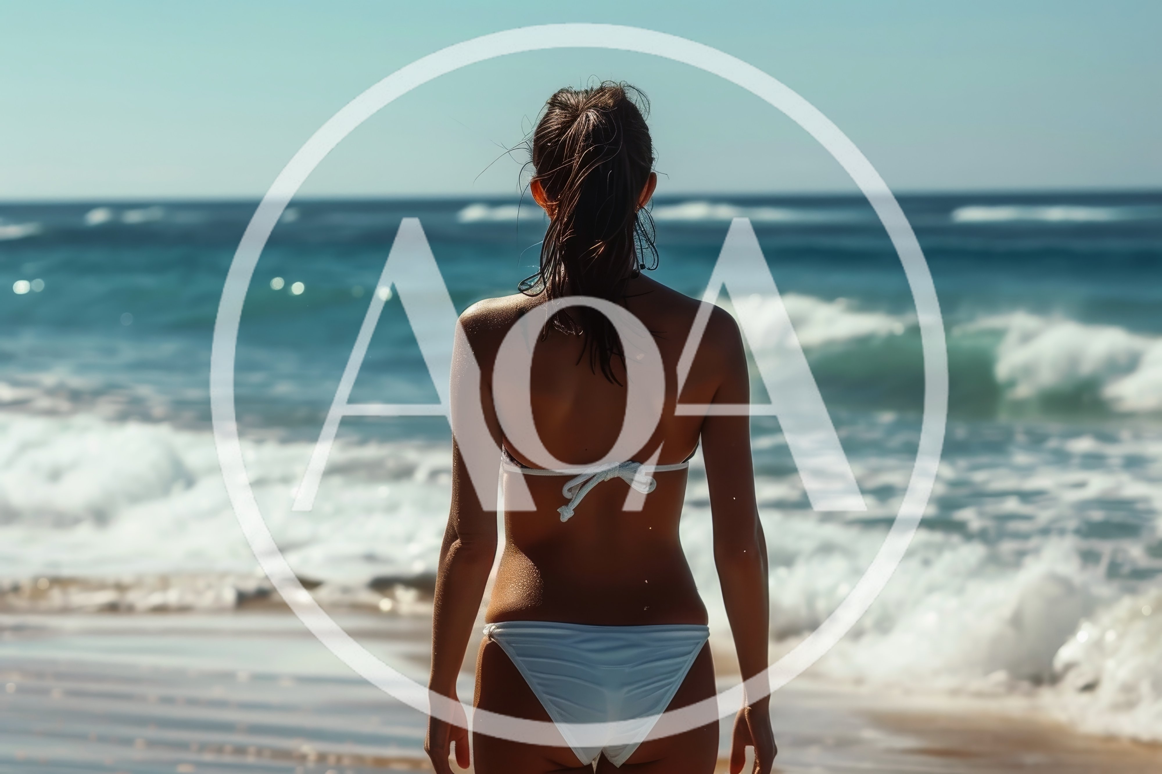Woman Standing On Beach Looking At Ocean Waves