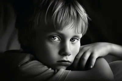 Portrait Of A Pensive Young Boy In Black And White