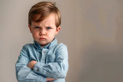 Angry Young Boy With Crossed Arms