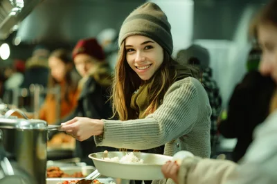 Young Woman Serving Food at a Community Soup Kitchen